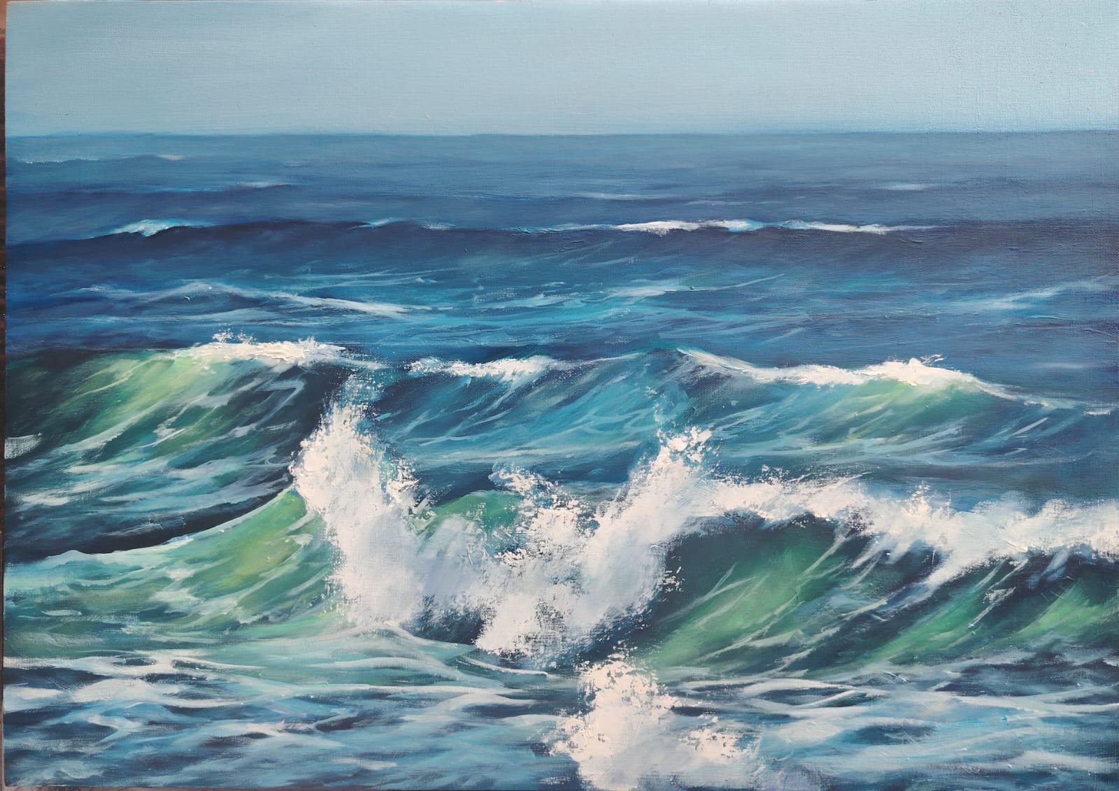 Wide open-ocean rolling waves